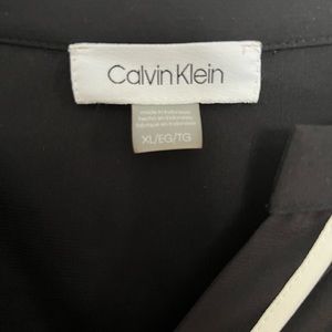 Multiple sleeveless blouses.